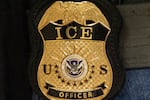 FILE - A federal agent wears an Immigration and Customs Enforcement badge in New York, June 10, 2025.