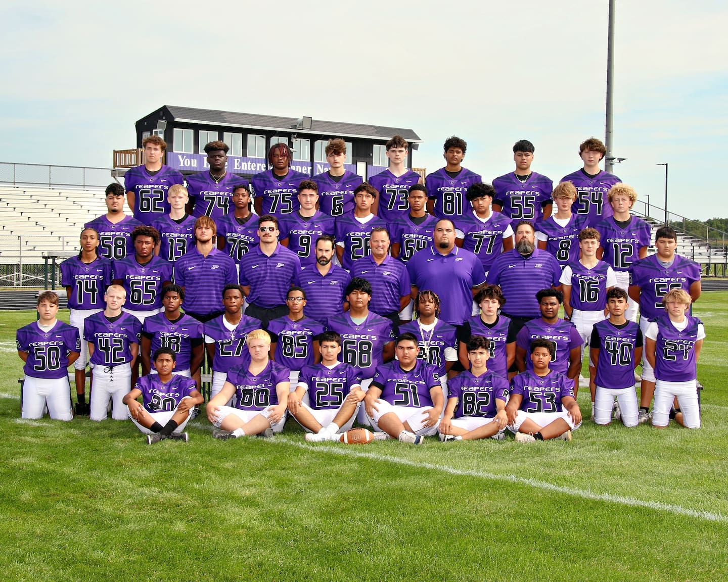 The 2024 Plano junior varsity football team poses for a team photo. Assistant coach Phil LoChirco stands on the third row, fourth from left.