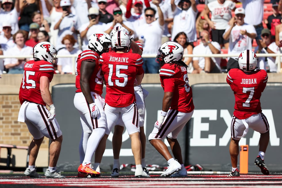 The Texas Tech defense celebrates a pick six by linebacker Austin Romaine (15) during the...