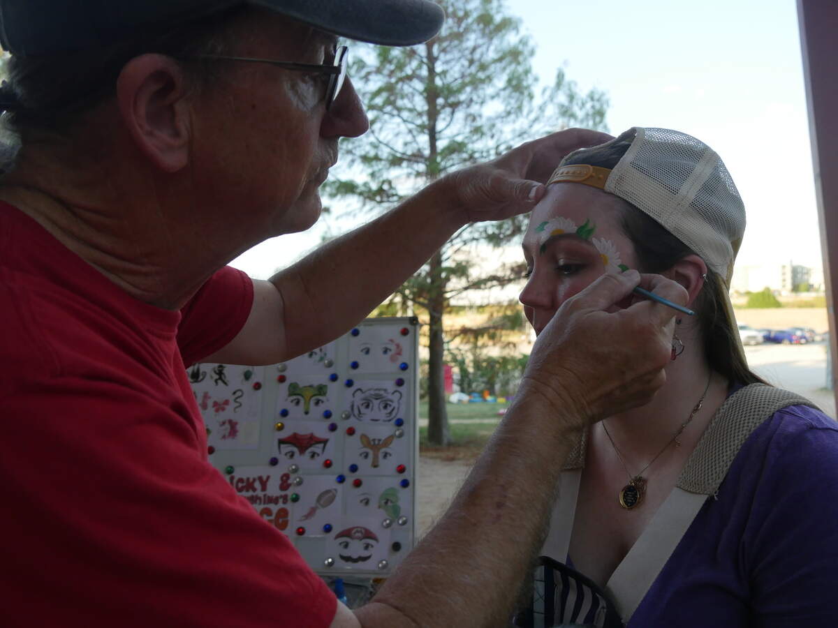 Caitlyn Truitt gets her face painted at the last night of operations at Fort Worth’s Coyote Drive-In by Eric Malmsten, who has been face painting at the theater with his wife Kerri-Jean for over a decade.
