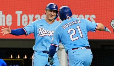Texas Rangers' Wyatt Langford, left, and Jake Burger (21) celebrate Burger's two-run home run that scored Langford during the fourth inning of a baseball game against the Tampa Bay Rays Sunday, Sept. 6, 2026, in Arlington, Texas. (AP Photo/Tony Gutierrez)