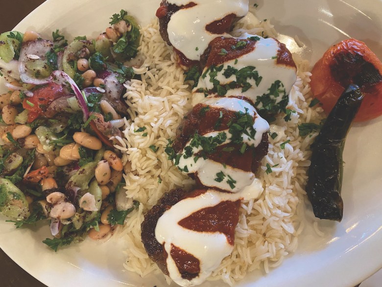 Selda’s Grilled Pistachio Meatballs are served over rice with a rustic tomato sauce and a drizzle of yogurt. 