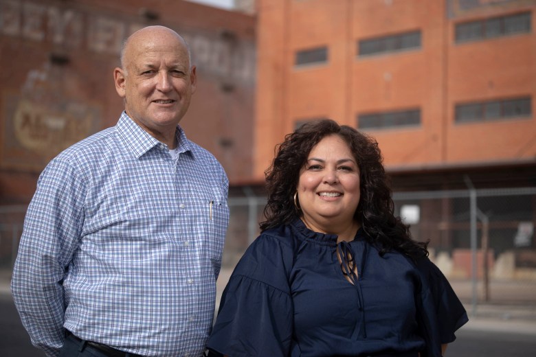 Rene Garcia and Julissa Carielo, partners at DreamOn Group stand in front of one of their next big projects, the Scobey Storage Complex, a mixed-use housing project with close access to transit.