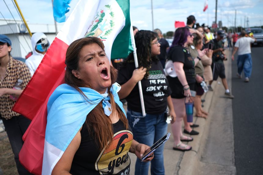 People protest where local authorities say a US Immigration and Customs Enforcement officer shot and wounded a man in Austin, Texas, on Sunday.