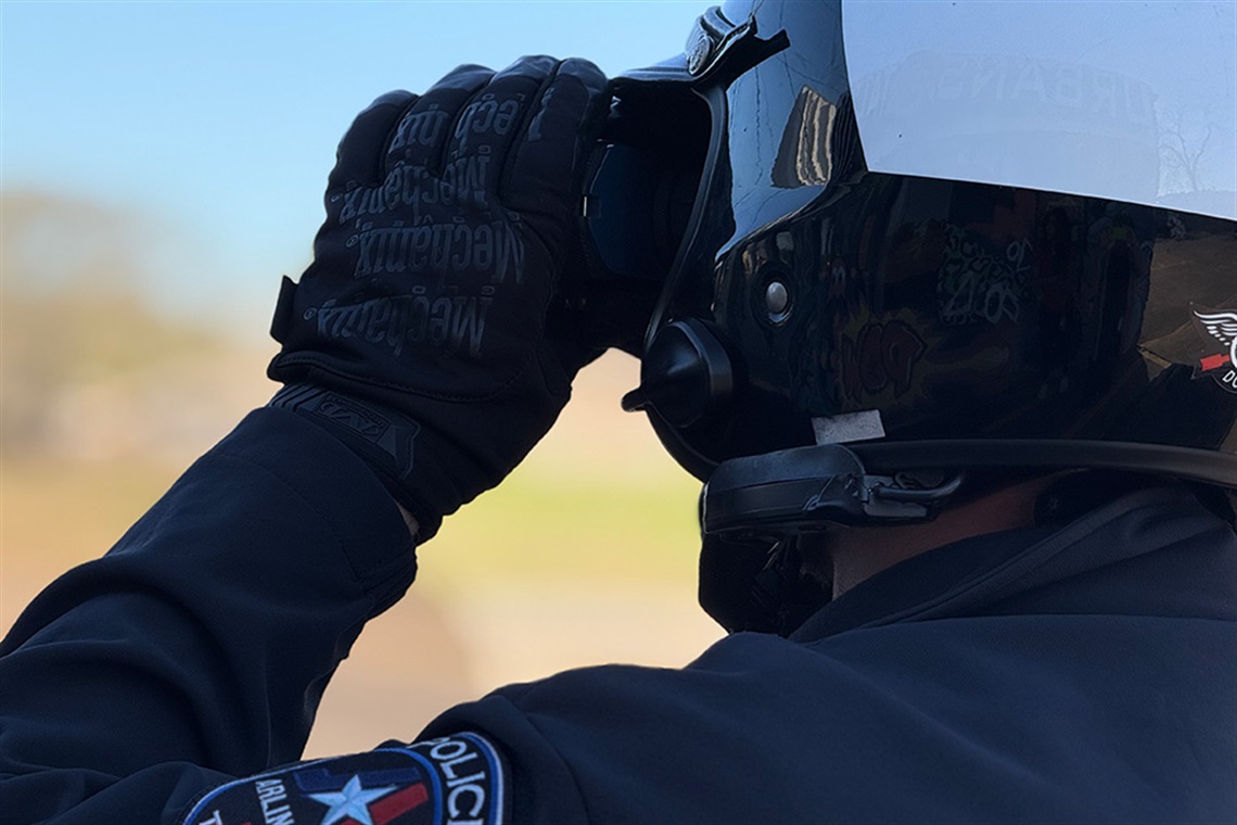 A motorcycle officer using a speed detection device