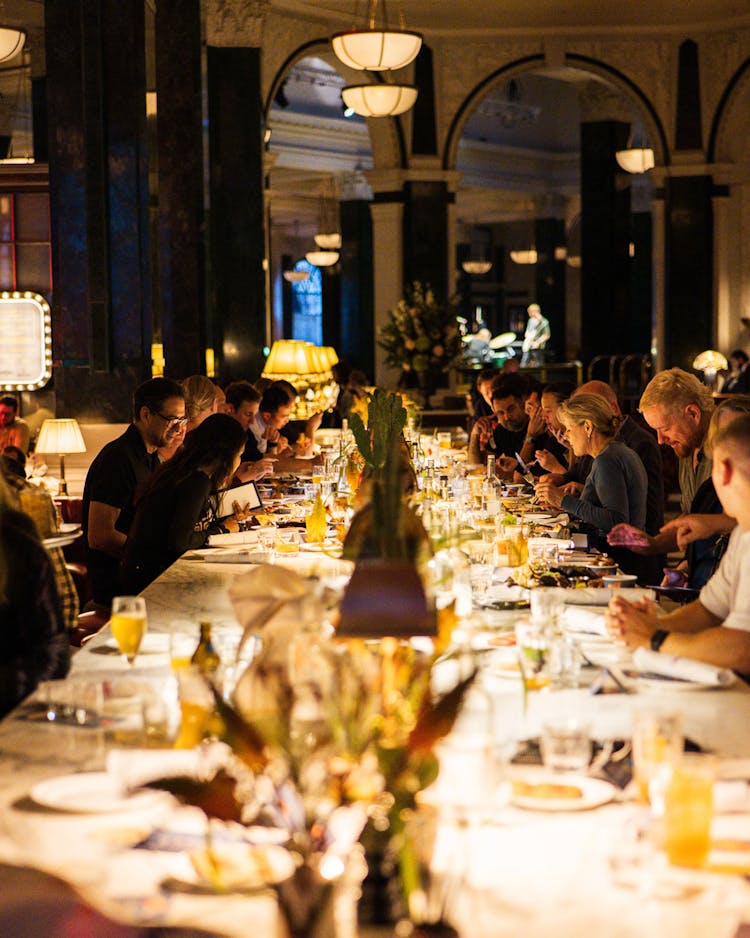 photo of guests dining at long dinner table