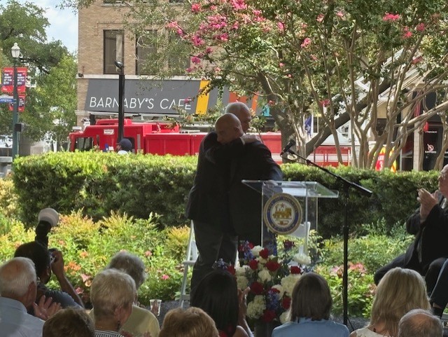 Mayor John Whitmire embraces Larry Catuzzi, father of Lauren Catuzzi-Grandcolas, who died on Sept. 11.