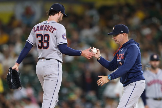 Houston Astros pitcher Peter Lambert hands the ball to manager Joe Espada, right, after being pulled during the third inning of a baseball game against the Athletics on Thursday, Sept. 24, 2026, in West Sacramento, Calif. (AP Photo/Scott Marshall)