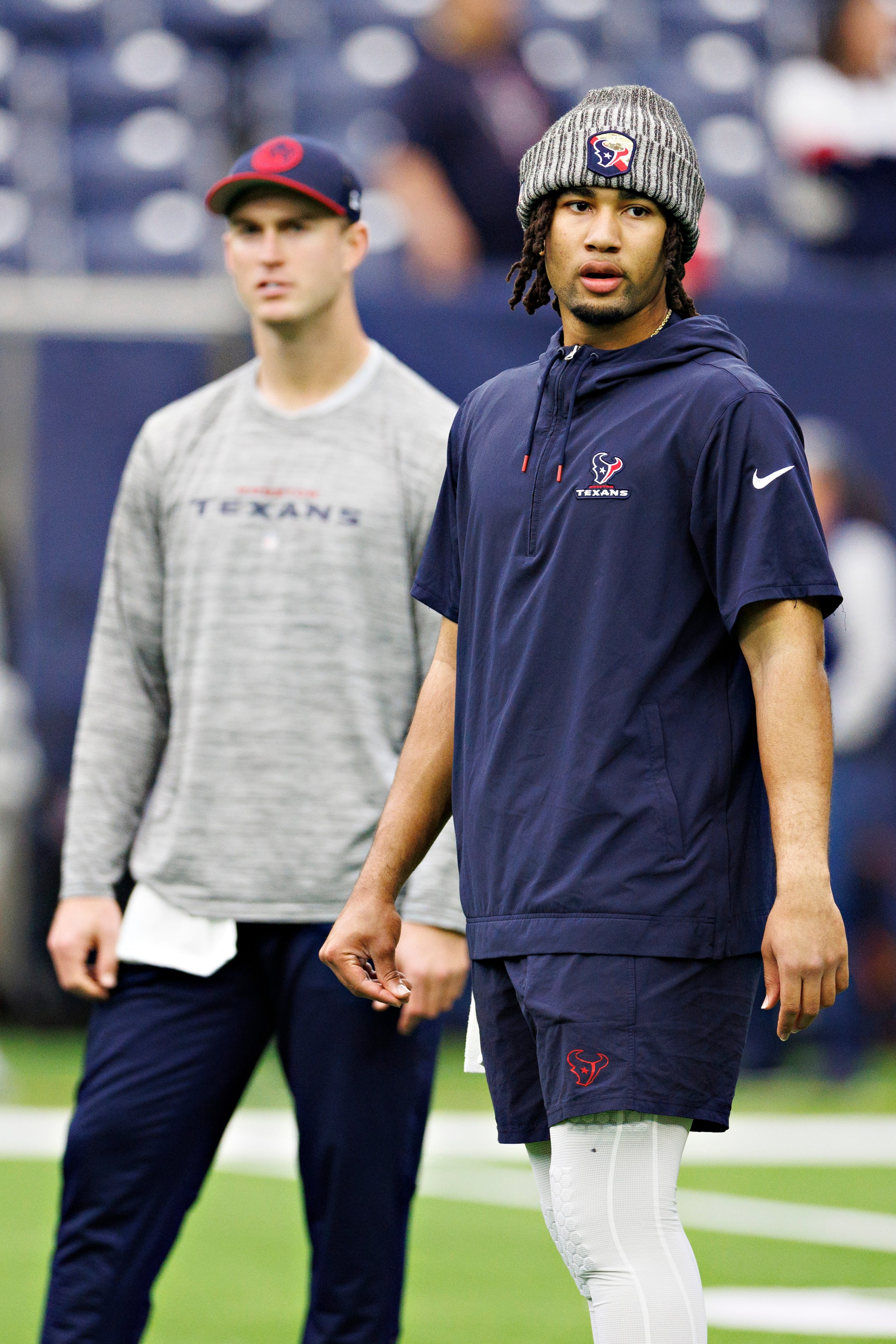 HOUSTON, TEXAS - DECEMBER 31: C.J. Stroud #7 and Davis Mills #10 of the Houston Texans warms up before the game against the Tennessee Titans at NRG Stadium on December 31, 2023 in Houston, Texas. The Texans defeated the Titans 26-3. (Photo by Wesley Hitt/Getty Images)