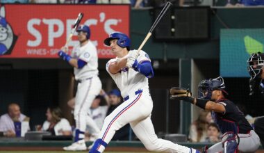 Texas Rangers designated hitter Justin Foscue watches his solo home run after finishing his swing.