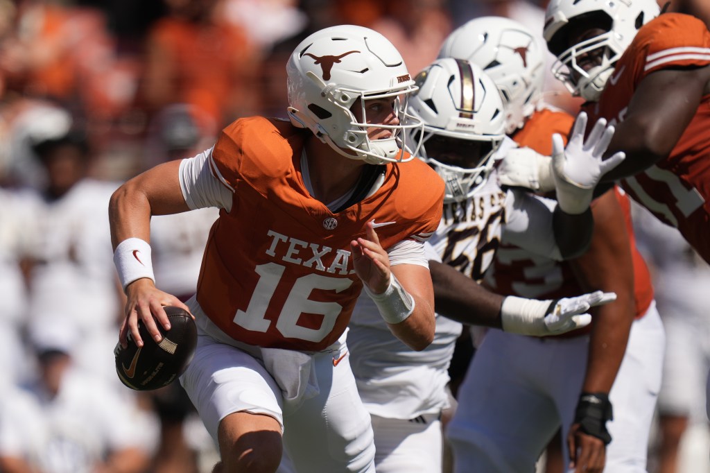Texas quarterback Arch Manning (16) scrambles against Texas State.