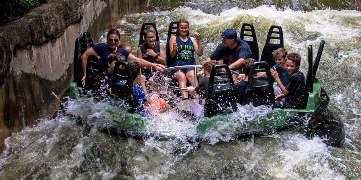 A group of people on Roaring Rapids at Six Flags Over Texas.