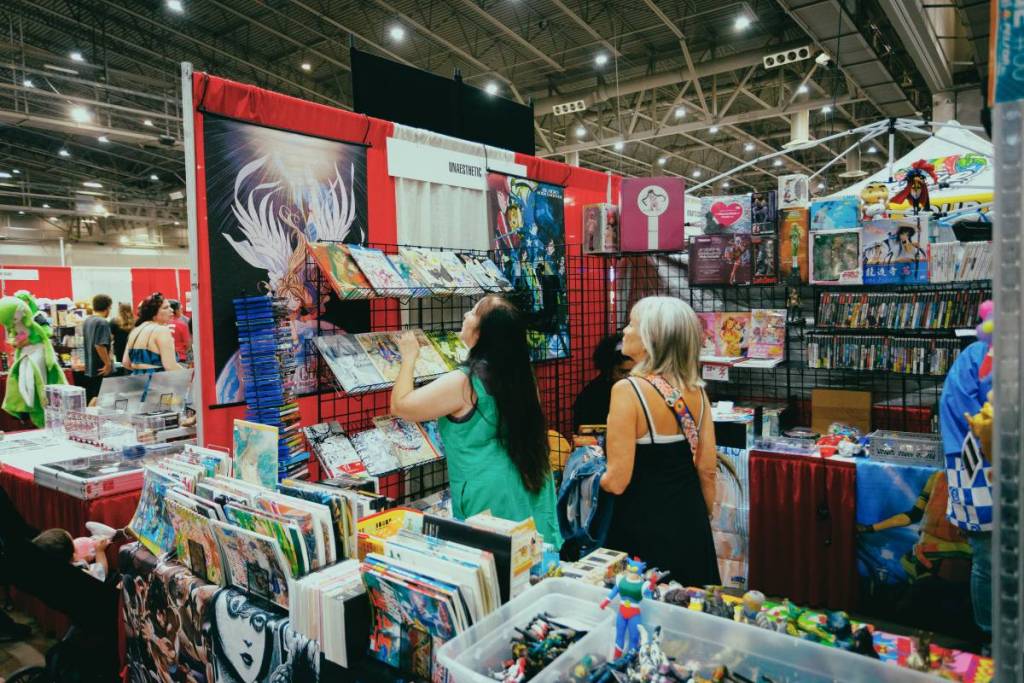 Image shows a group of people perusing a vendor at Tokyo X