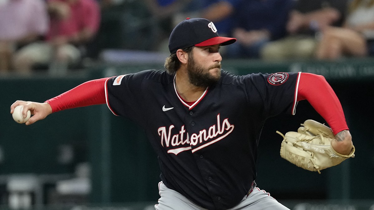 Washington Nationals pitcher Trevor Williams reaches back to deliver in his navy road uniform at Globe Life Field.