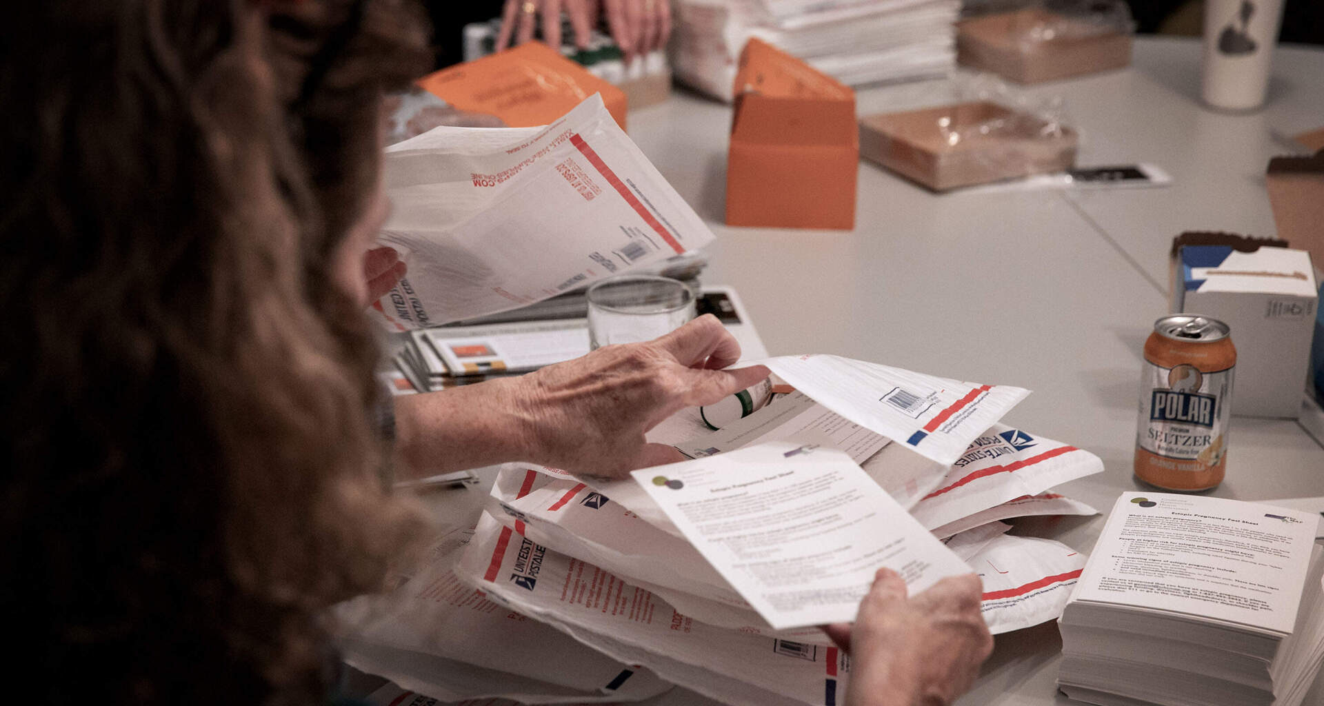Massachusetts Medication Abortion Access Project volunteers pack envelopes with medication and information. (Robin Lubbock/WBUR)