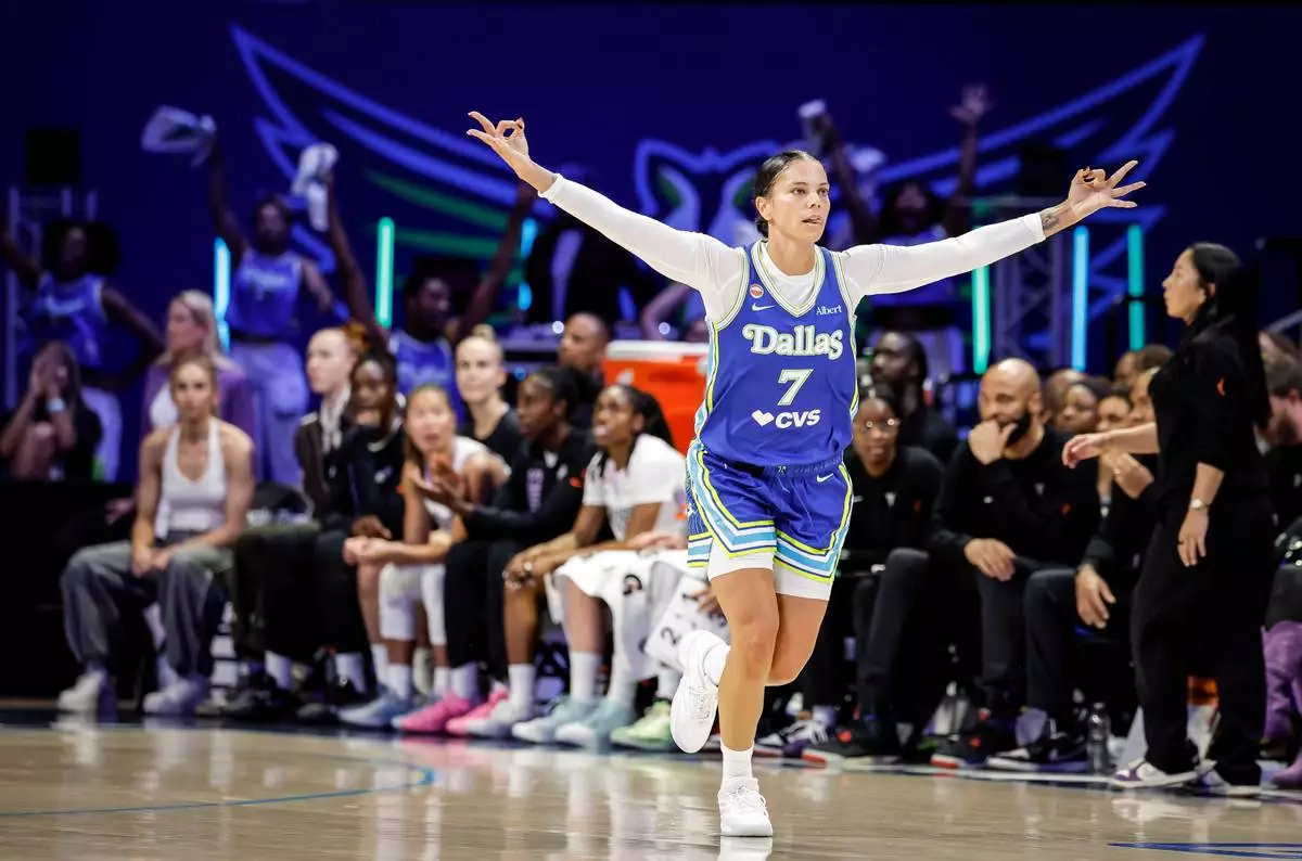 Alysha Clark (7) celebrates a 3-point basket in the first half as the Golden State Valkyries play the Dallas Wings in Game 2 of the WNBA playoffs first round in Arlington, Texas, on Wednesday, Sept. 30, 2026. (Carlos Avila Gonzalez/San Francisco Chronicle via AP)