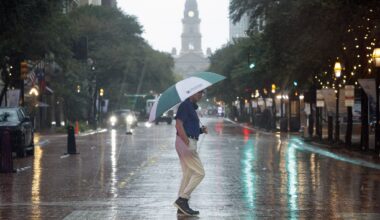 A man crosses Main Street with an umbrella in downtown Fort Worth on Thursday, Oct. 1, 2026.