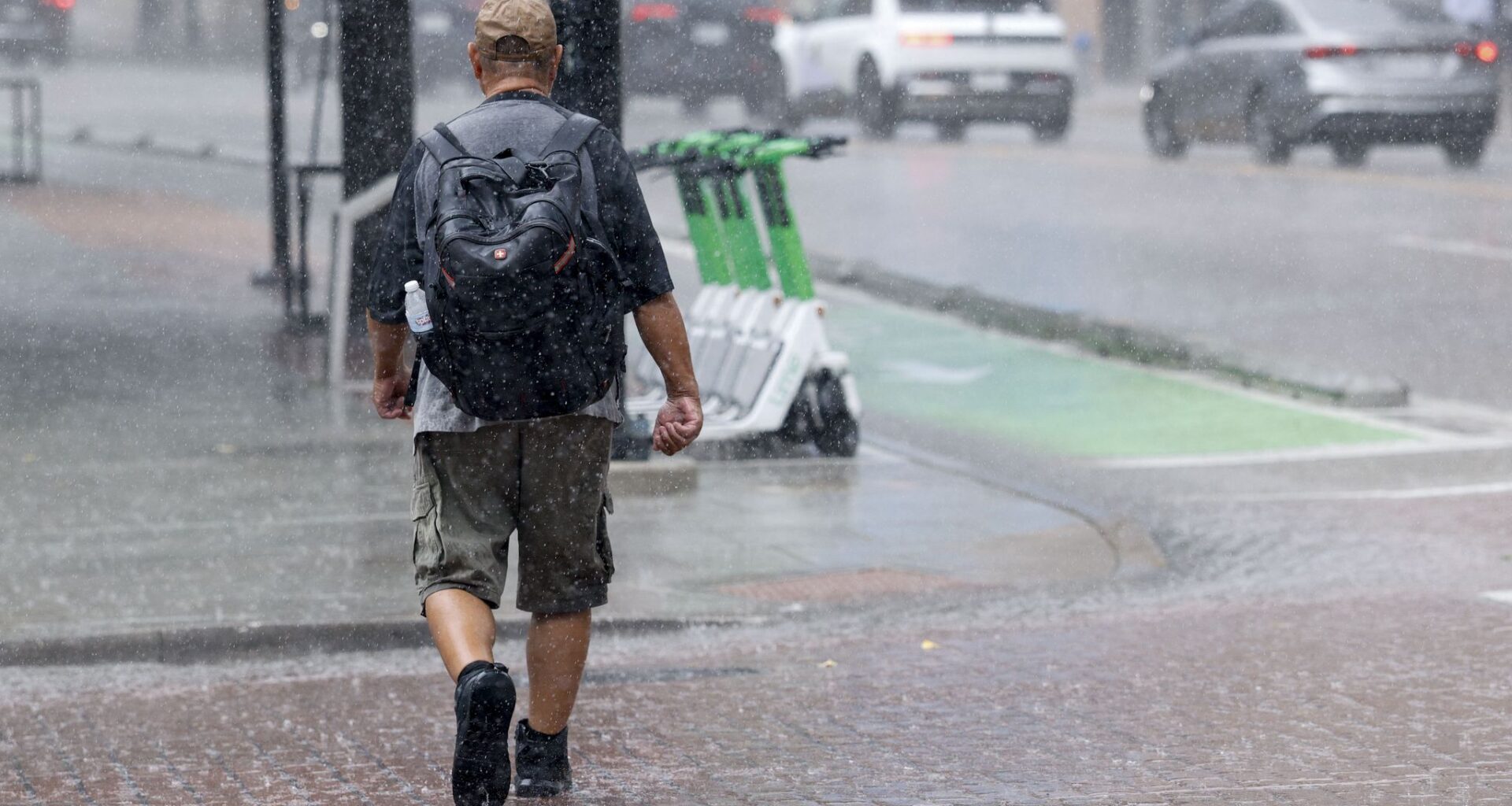 A man crosses Commerce Street in heavy rain, Wednesday, Sept. 30, 2026, in downtown Dallas.