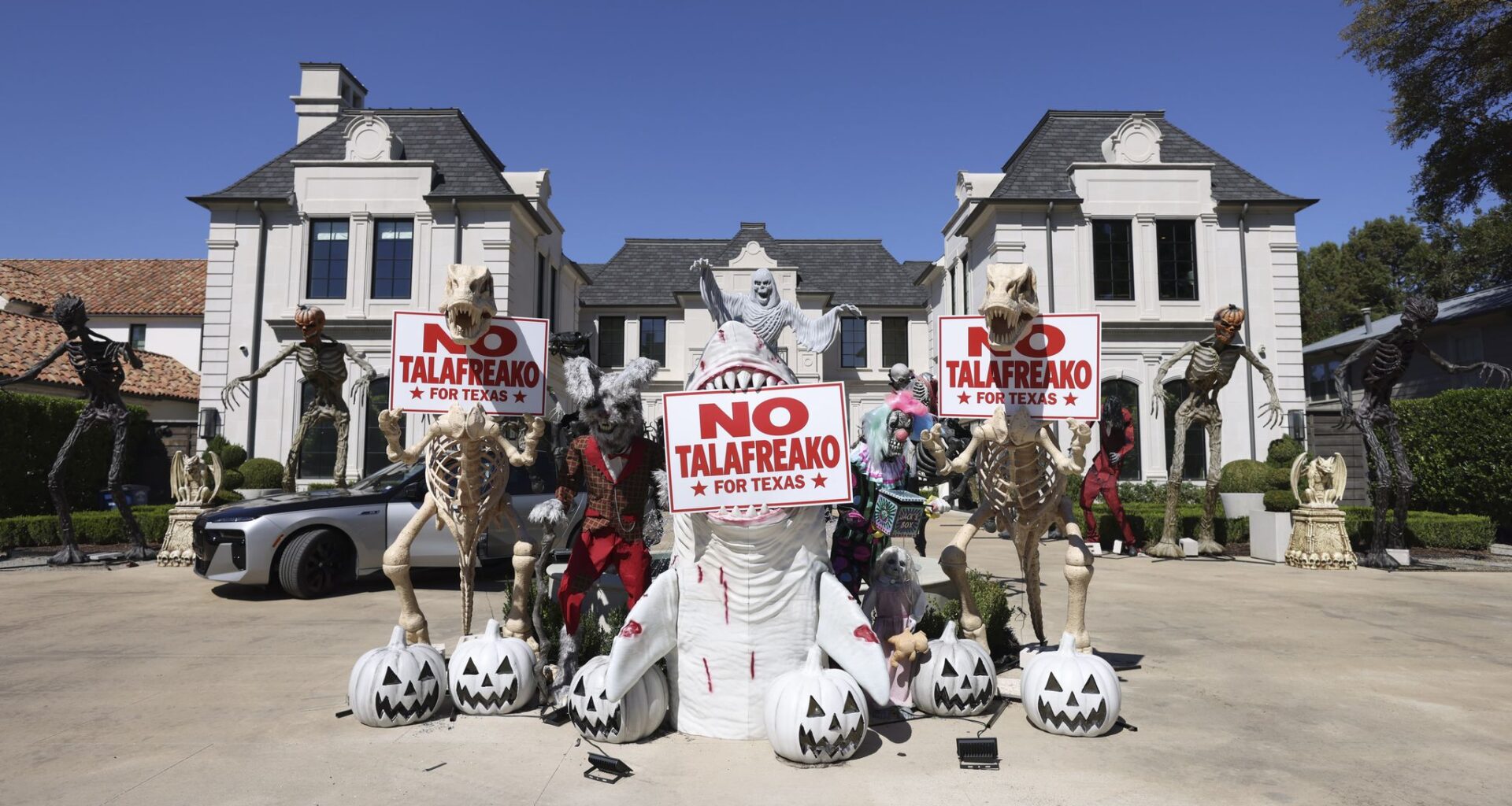 Anti-James Talarico political signage is displayed among Halloween decor in the driveway of a house along Deloache Avenue, Tuesday, Oct. 6, 2026, in Preston Hollow.