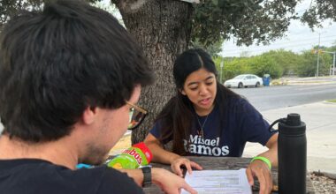 This photo taken with a smartphone shows two members of the Democratic Socialists of America, Mark Ramirez and Clarisse Manuel, during a day of canvassing Saturday, Sept. 26, 2026, in Austin, Texas. (AP Photo/Jesse Bedayn)