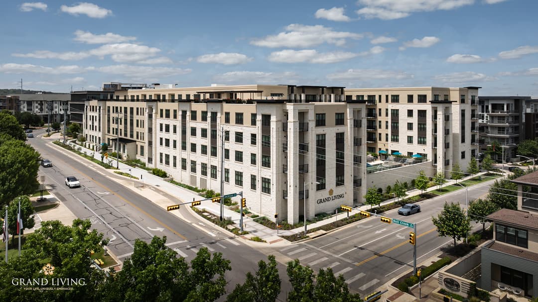 Aerial view of the large Grand Living apartment complex at the corner of Jackson and Bull Creek Road.