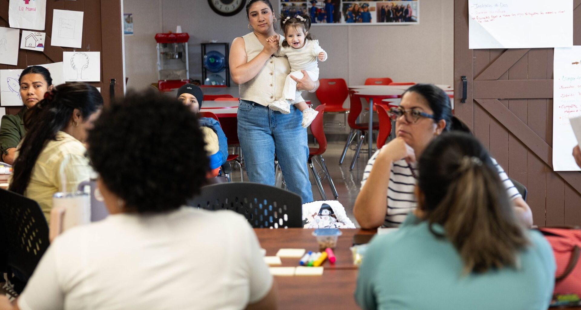 Maria Elena Gonzalez Rodriguez holds daughter Emma Aurora Pina Gonzalez and listens to a lecture at Bachman Lake Together Family Center in Dallas on Tuesday, Oct. 6, 2026.