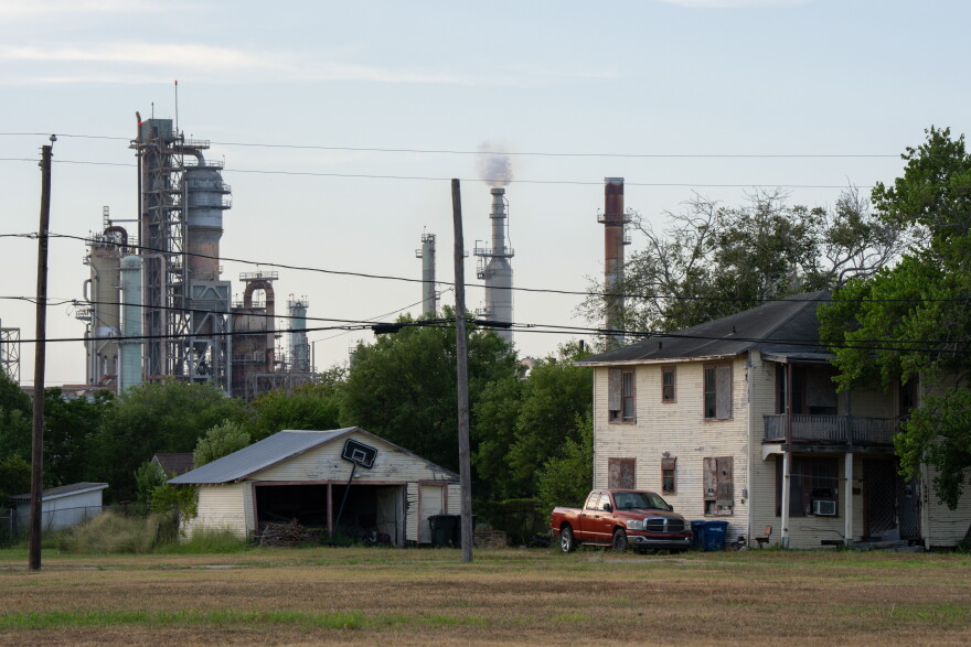 A refinery towers in the background of homes in the Hillcrest neighborhood in Corpus Christi.
