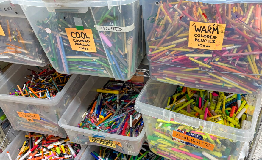 Multiple bins of colored pencils sit on a shelf at Austin Creative Reuse.