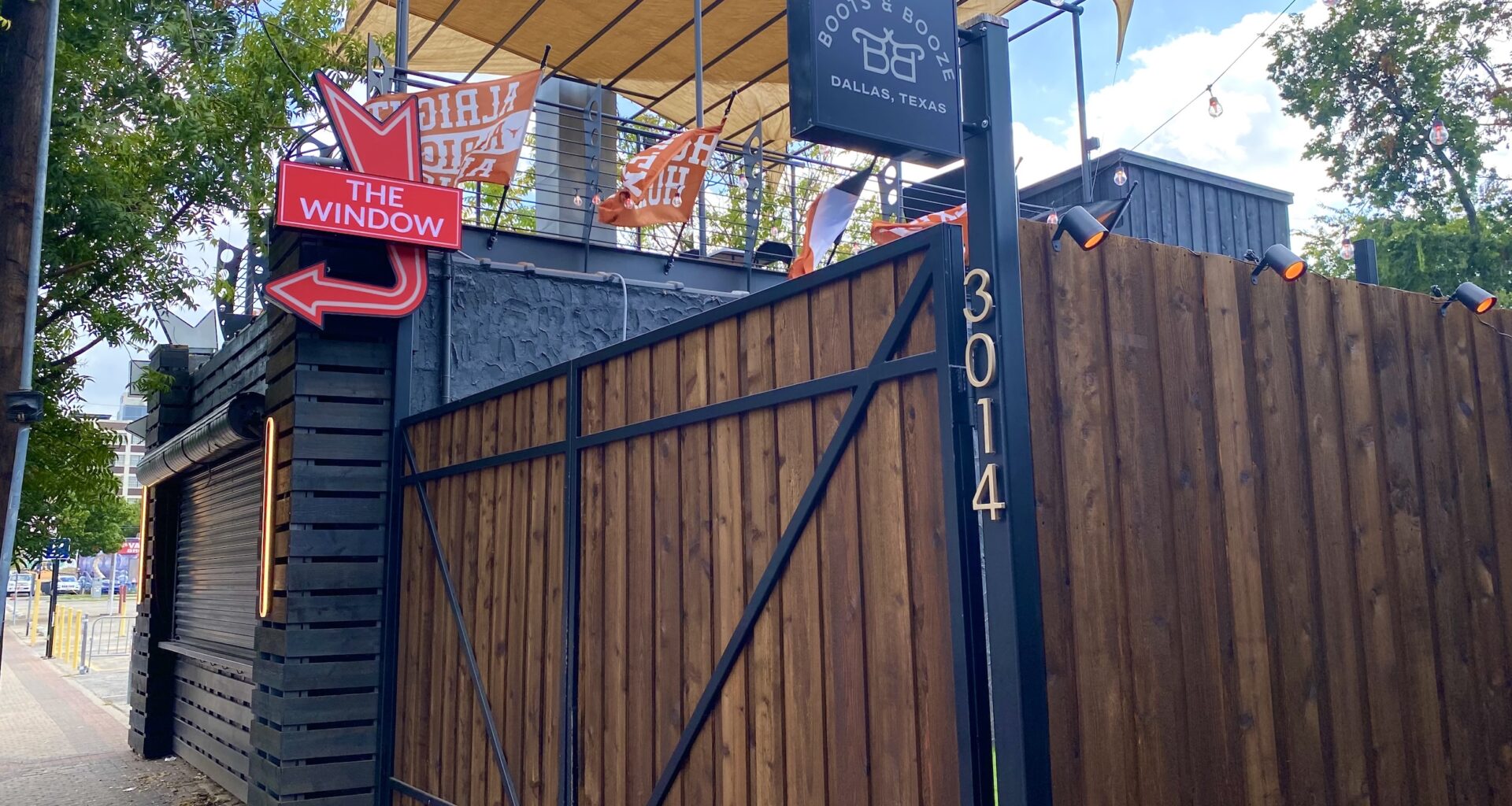 boots and booze sign and fence in deep ellum
