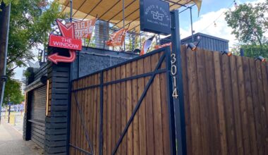 boots and booze sign and fence in deep ellum
