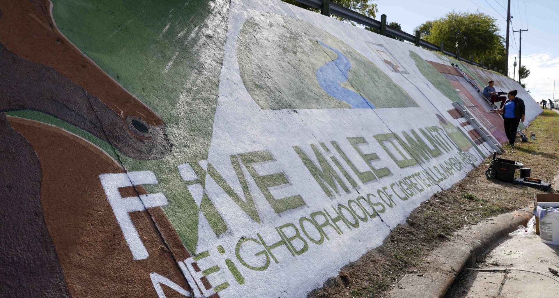 Artists and community members work to paint and restore the Five Mile Community Mural along South Lancaster Road on Sunday, Oct. 18, 2026, in Dallas.