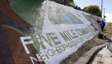 Artists and community members work to paint and restore the Five Mile Community Mural along South Lancaster Road on Sunday, Oct. 18, 2026, in Dallas.