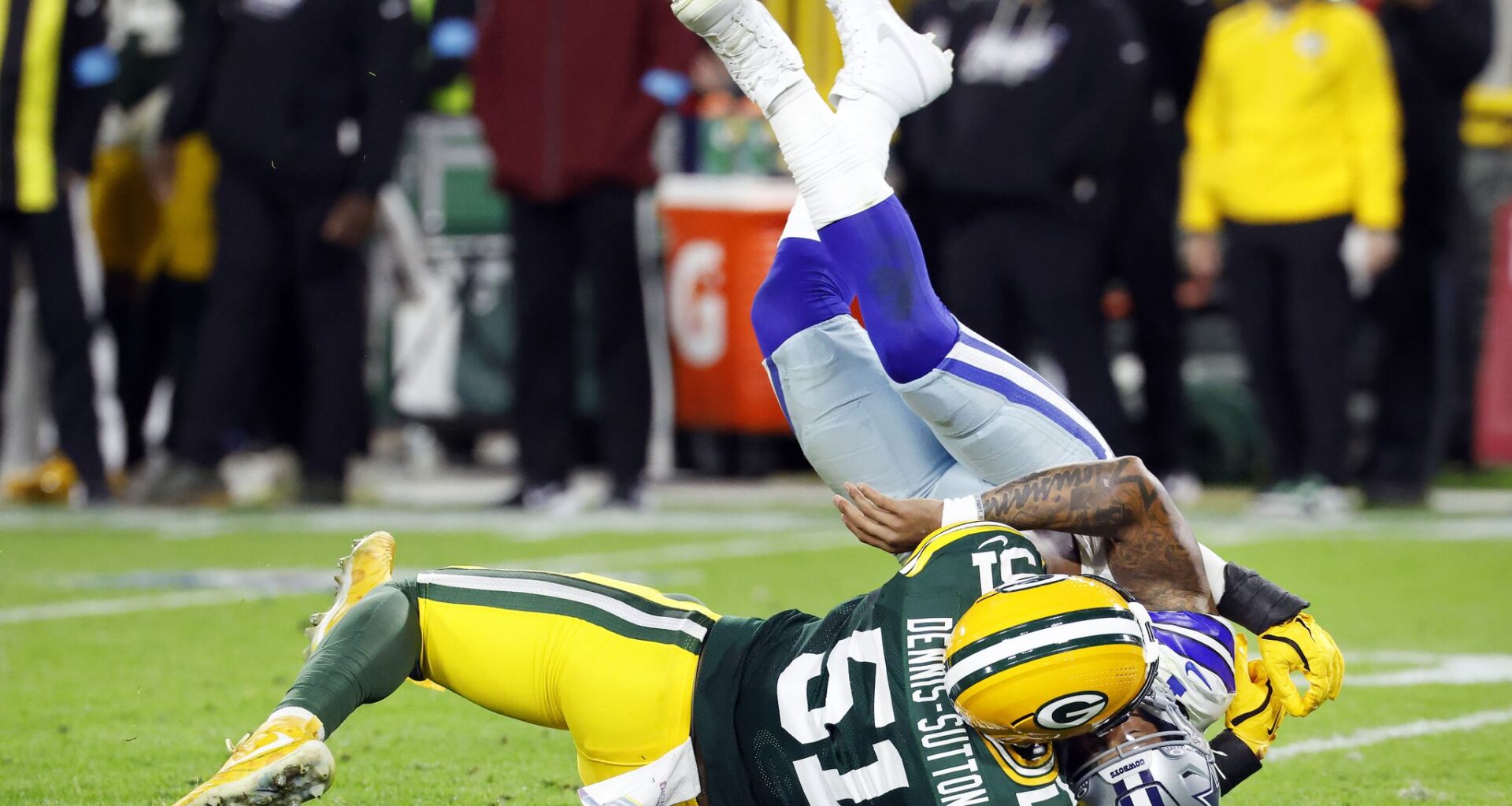 Dallas Cowboys defensive tackle Lt Overton (99) leans over in a chair as he and his defensive teammates watch the Green Bay Packers run out the clock during the fourth quarter at Lambeau Field in Green Bay, Wisconsin, October 18, 2026.