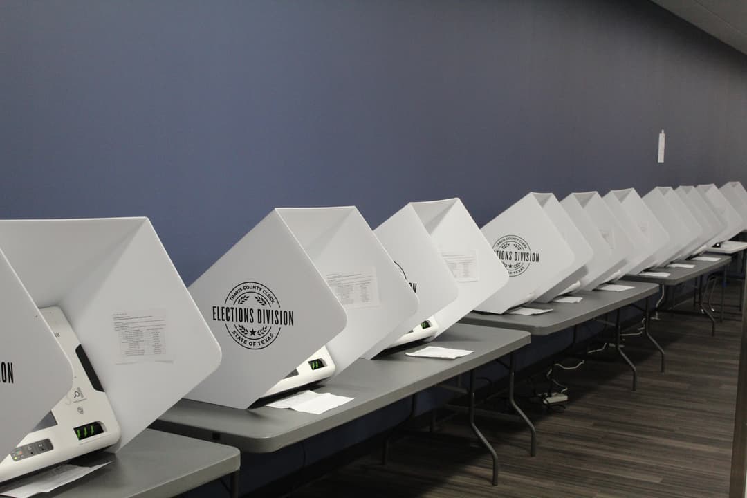 A row of Travis County voting machines.