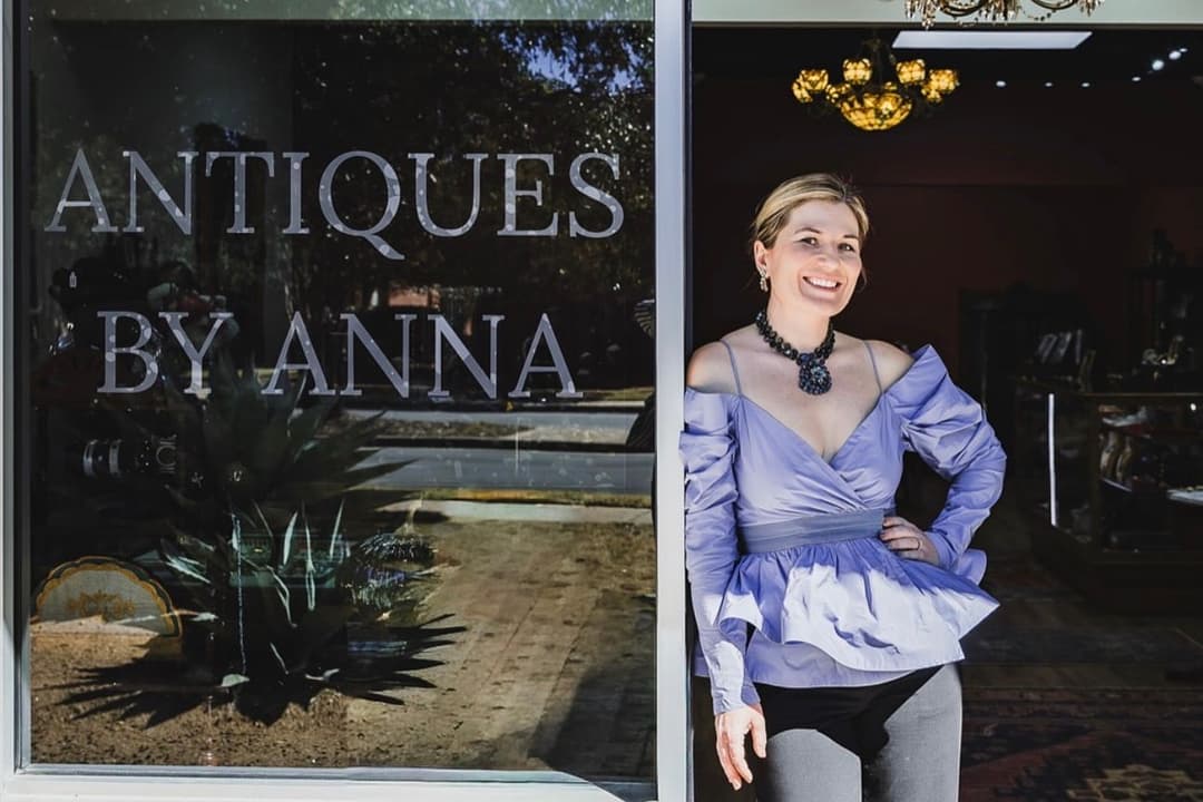 Antiques by Anna owner Anna Mazaikina in front of store sign