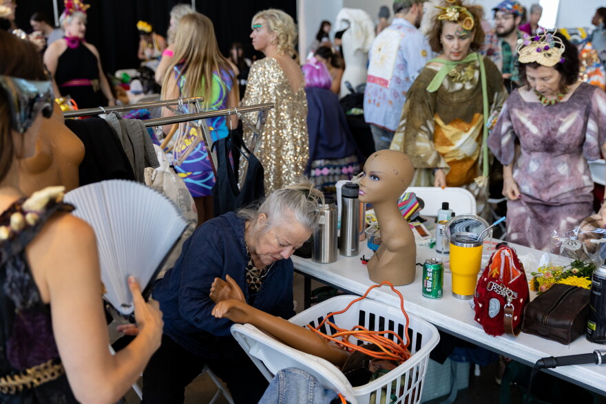 Designers and models work backstage at the Austin Creative Reuse “Reuse on the Runway 2026” show in Austin, Texas, on Oct. 17, 2026. Joe Ferrara / KUT News