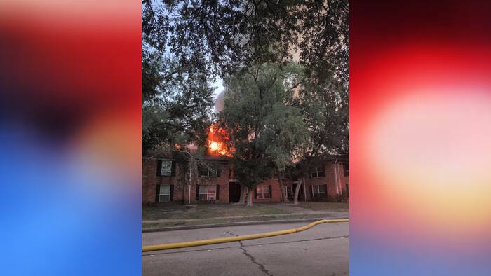 Flames seen coming from building as firefighters respond to SW Houston apartment fire