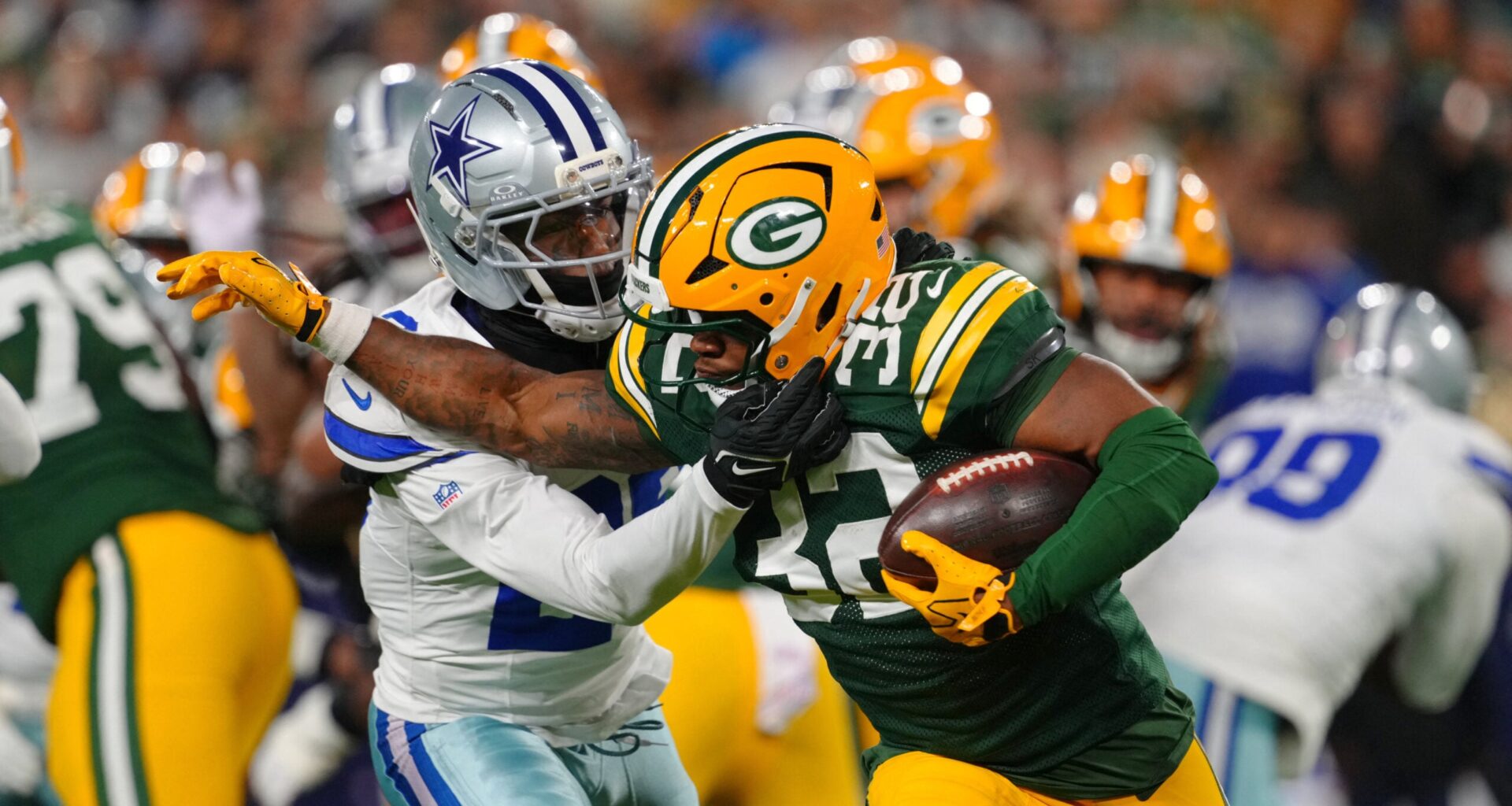 Oct 18, 2026; Green Bay, Wisconsin, USA; Green Bay Packers running back MarShawn Lloyd (32) runs the ball against Dallas Cowboys cornerback DaRon Bland (26) during the during the first quarter at Lambeau Field.