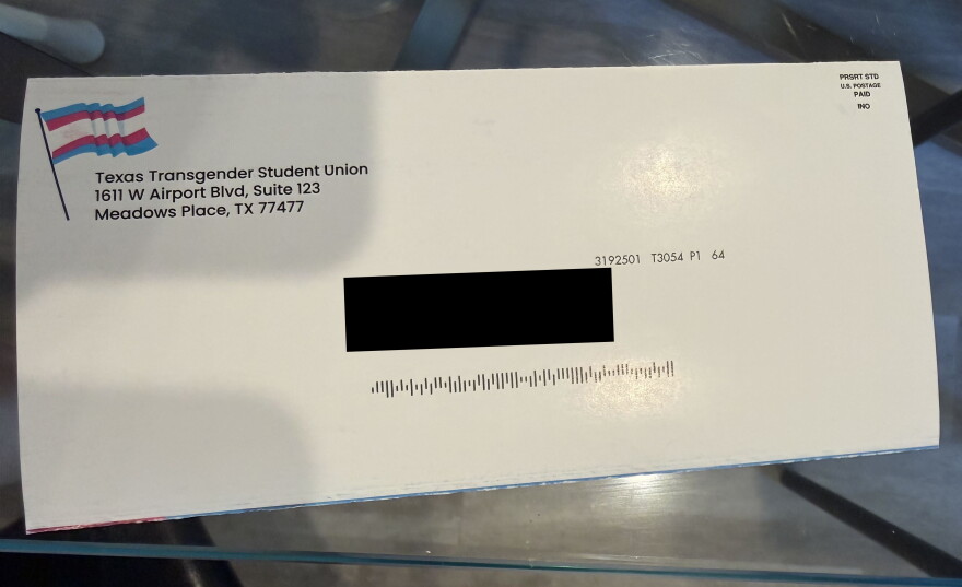 An envelope with the address blacked out.