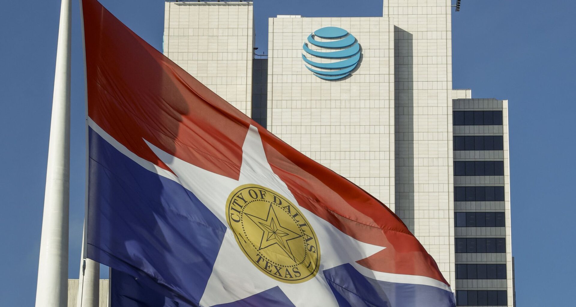 A City of Dallas flag flies in front of AT&T headquarters building Whitacre Tower in downtown Dallas, Monday, Jan. 5, 2026.