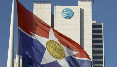 A City of Dallas flag flies in front of AT&T headquarters building Whitacre Tower in downtown Dallas, Monday, Jan. 5, 2026.