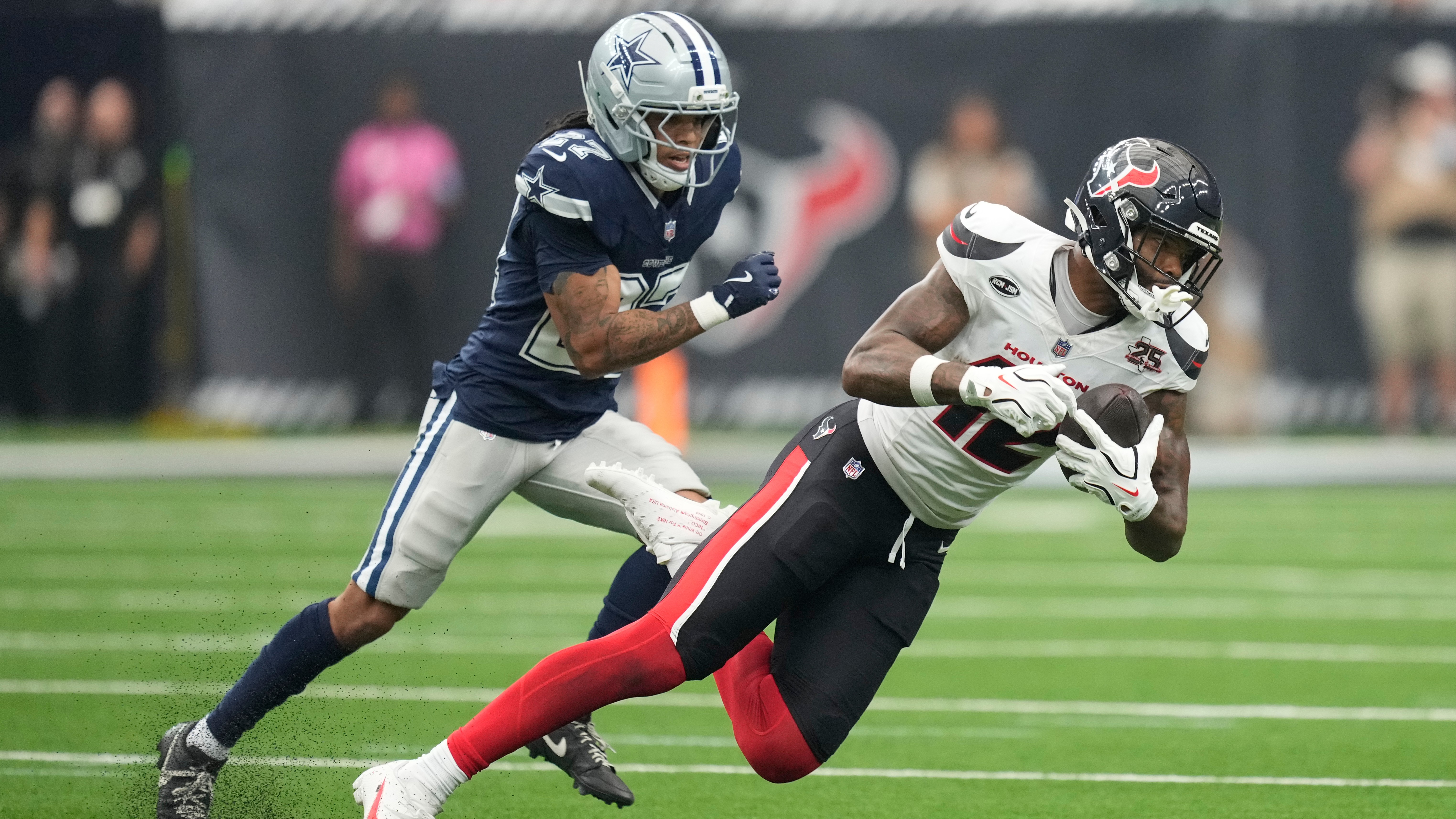 Texans wide receiver Nico Collins makes a catch as Cowboys cornerback Reddy Steward defends during the second half of an NFL football game in Houston, Sunday, Oct. 4, 2026.