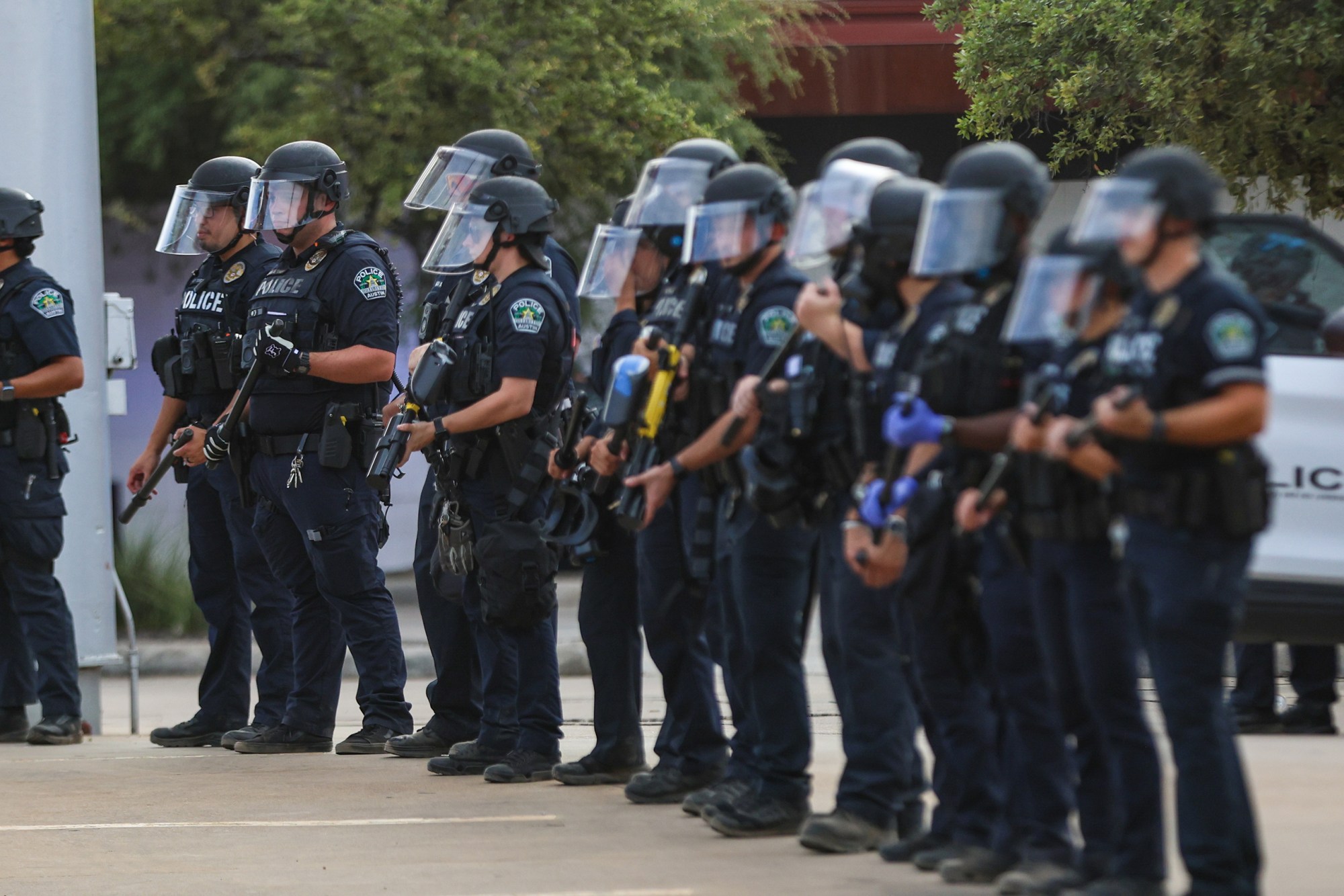 Austin police hold pepper ball guns as protestors confront officers after an immigration enforcement agent shot and injured Wilber Rafael Garces Perez, 28, of Venezuela, on Sunday Sept. 20, 2026.
