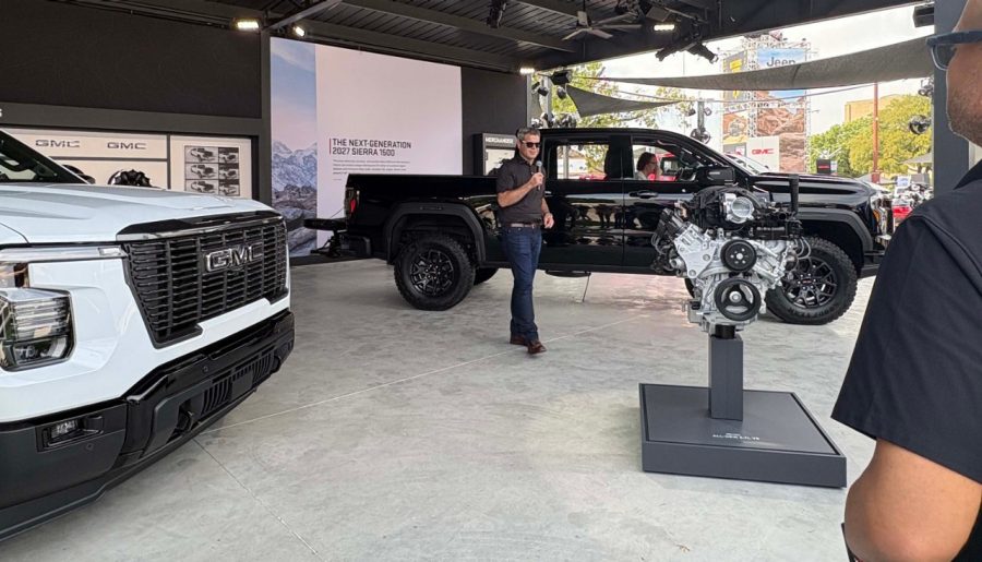 Global Vice President, Buick GMC Michael MacPhee presents on media day at the fair Black 2027 GMC Sierra with person speaking in front of it