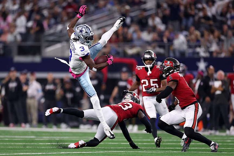 Dallas Cowboys wide receiver George Pickens (3) catches a pass over Tampa Bay Buccaneers defenders in the second half of an NFL football game in Arlington, Texas on Thursday, Oct. 8, 2026. (AP Photo/Sam Hodde)