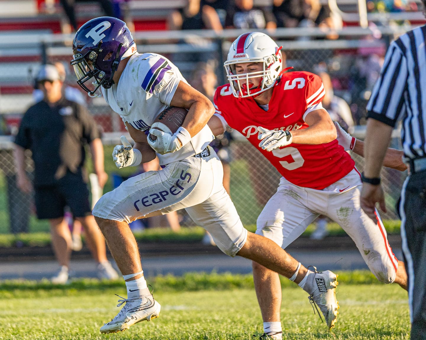 Ethan Taxis (3) of Plano runs ball as Joseph Donahue (5) Ottawa trails on Saturday, August 22, 2026 at King Field in Ottawa.