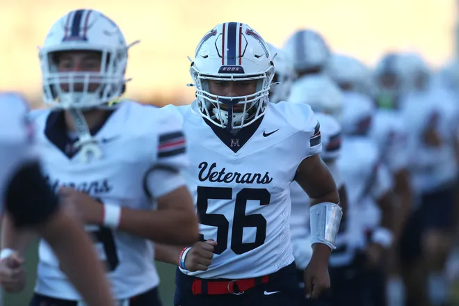 Veterans Memorial senior Aiden Flores and the Eagles jog onto the field before a district football game against Carroll at Buccaneer Stadium on Friday, Oct. 9, 2026.