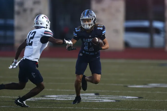 Carroll's Steven McChester looks to maneuver around Veterans Memorial's Javen Cruz-Levene during a district game at Buccaneer Stadium on Friday, Oct. 9, 2026.