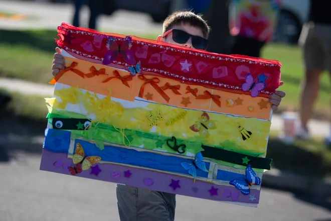A marcher shows off their handmade sign at the Pride Parade and Block Party hosted by Pride Corpus Christi at Water's Edge Park in Corpus Christi, Texas, on Oct. 10, 2026.