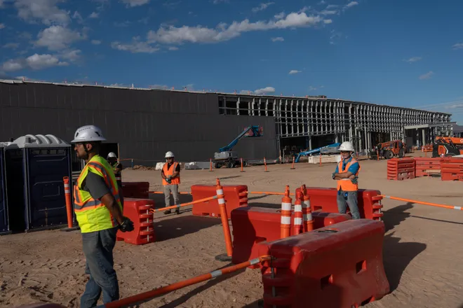 A data center building is seen in the background as members of the media tour Project Jupiter in Santa Teresa, N.M., on Tuesday, Oct. 13, 2026.